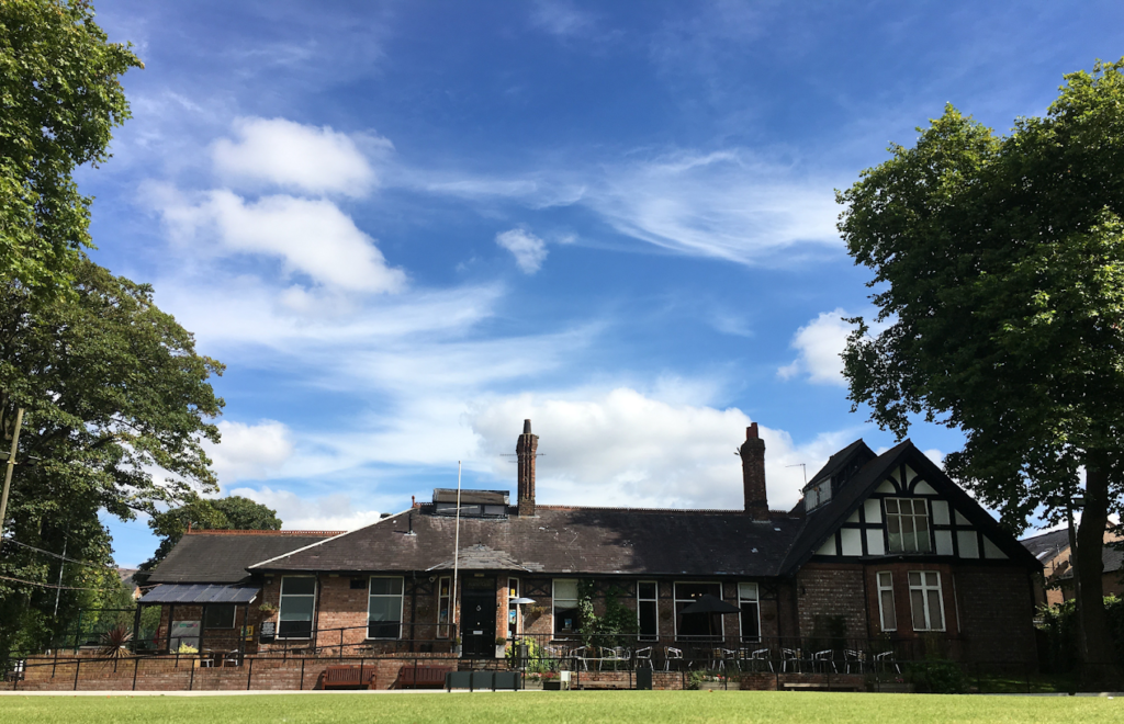 Photograph of The Albert Club in the sunshine with a blue sky above it.