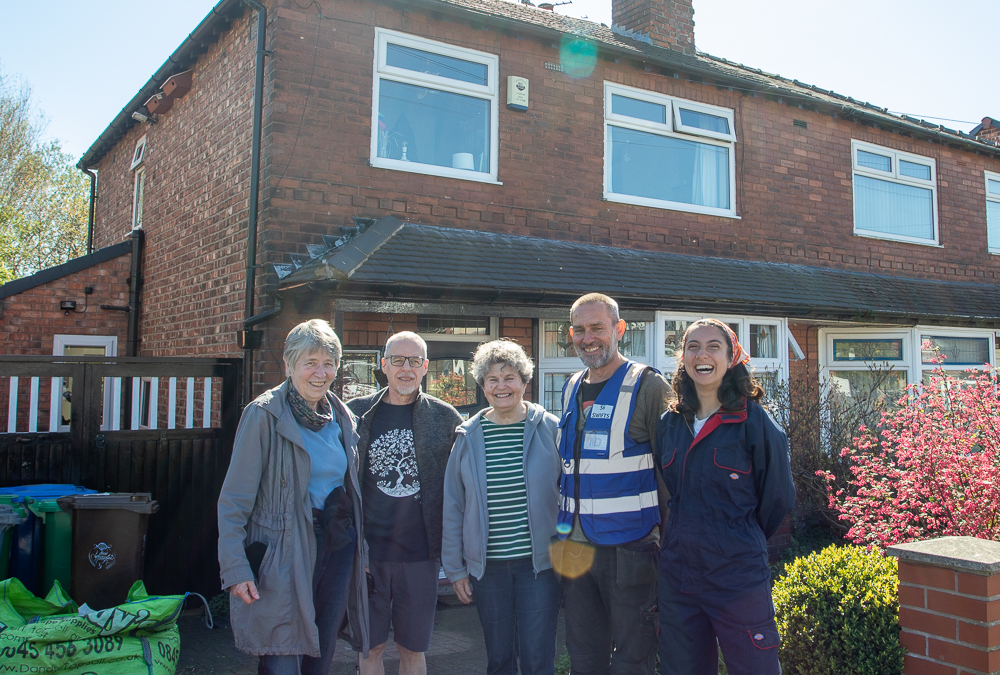 Local residents in Chorlton stand outside a house on their new 'swift street'